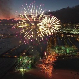 fireworks in the sky over a body of water