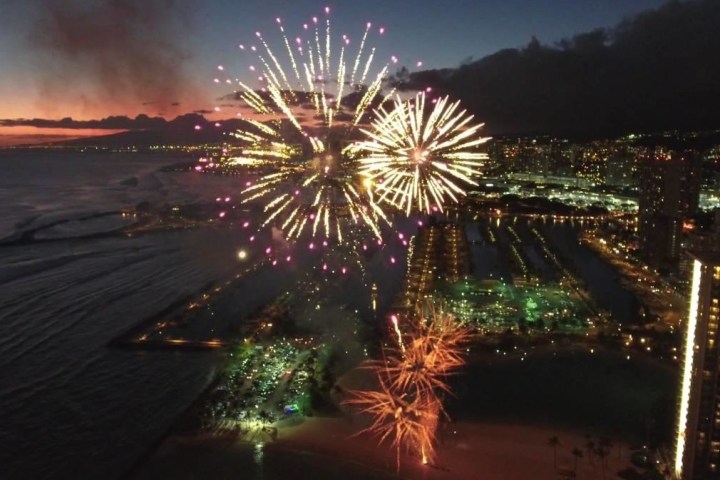 fireworks in the sky over a body of water