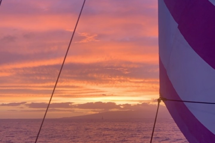 a man standing next to a body of water