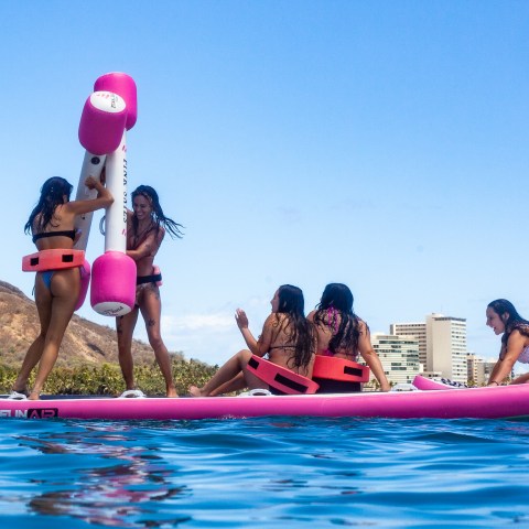 a group of people riding on the back of a boat in the water