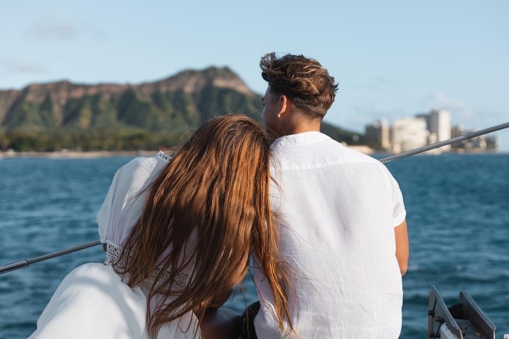 a person standing next to a body of water